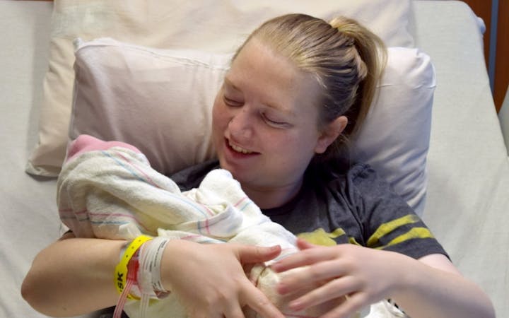 Bobbie holds Sydney, CoxHealth's first baby of 2018.