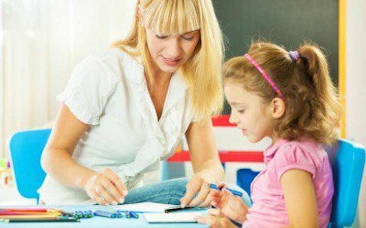 A woman and child sit together, representing the work Parents as Teachers staff will do.