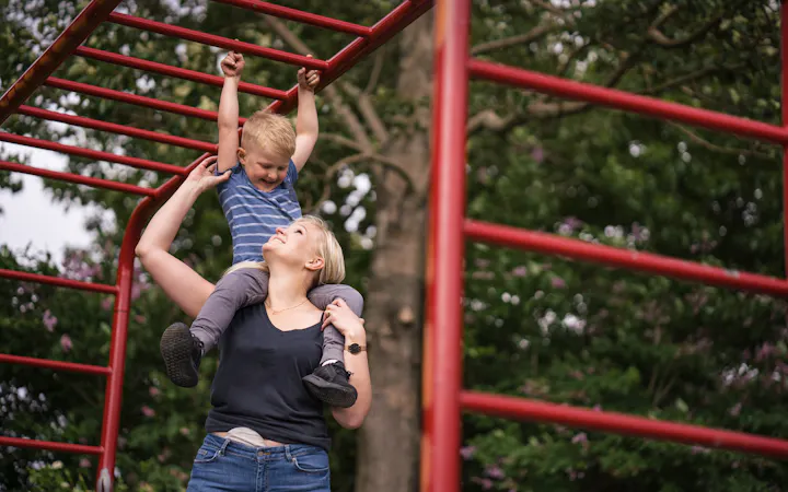 Woman with stoma bag cover at the park with her child
