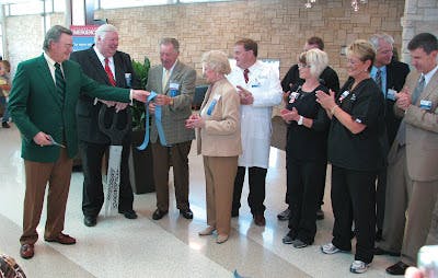 Bob Bezanson cuts ribbon at Cox South