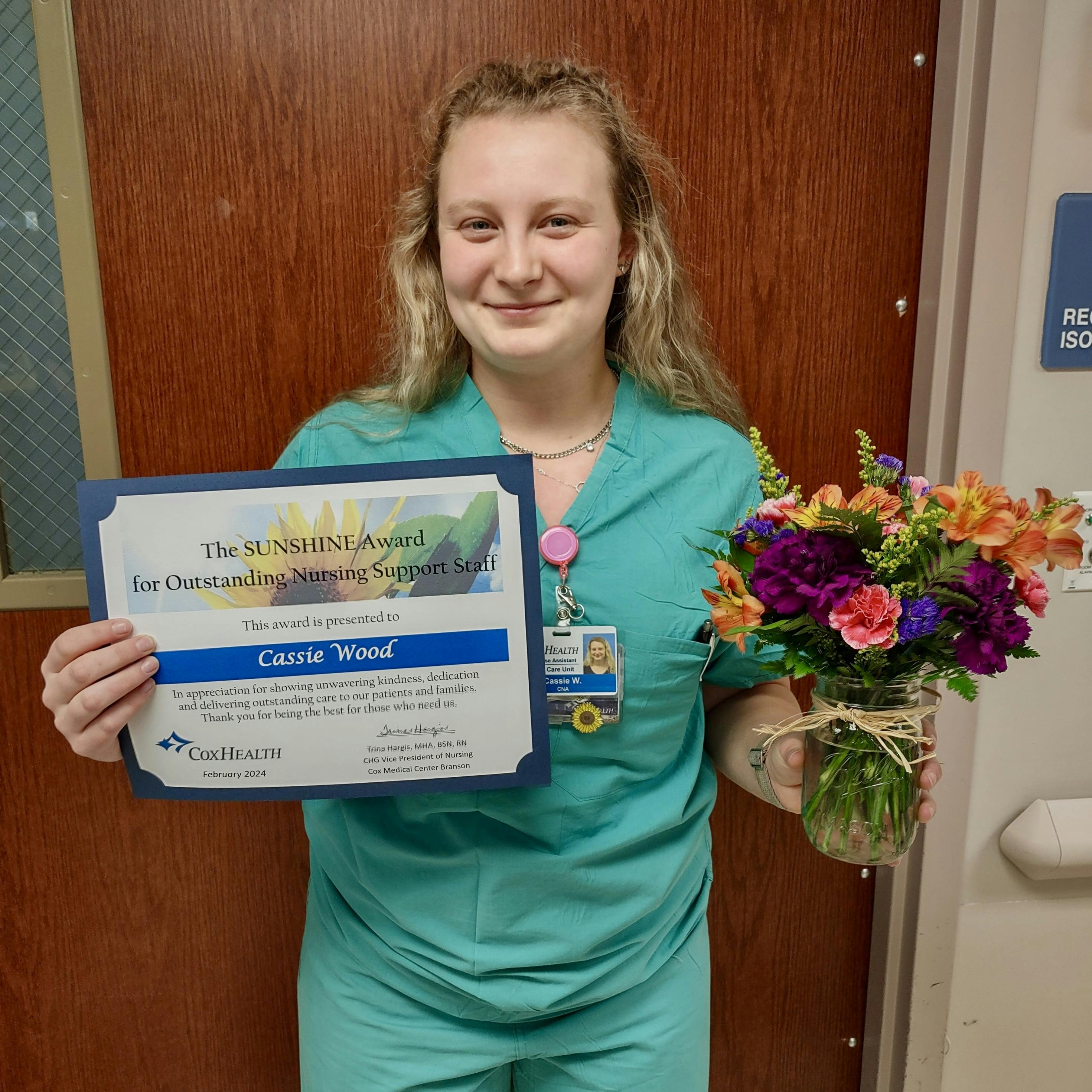 Cassie Wood displays her CoxHealth Sunshine Award.
