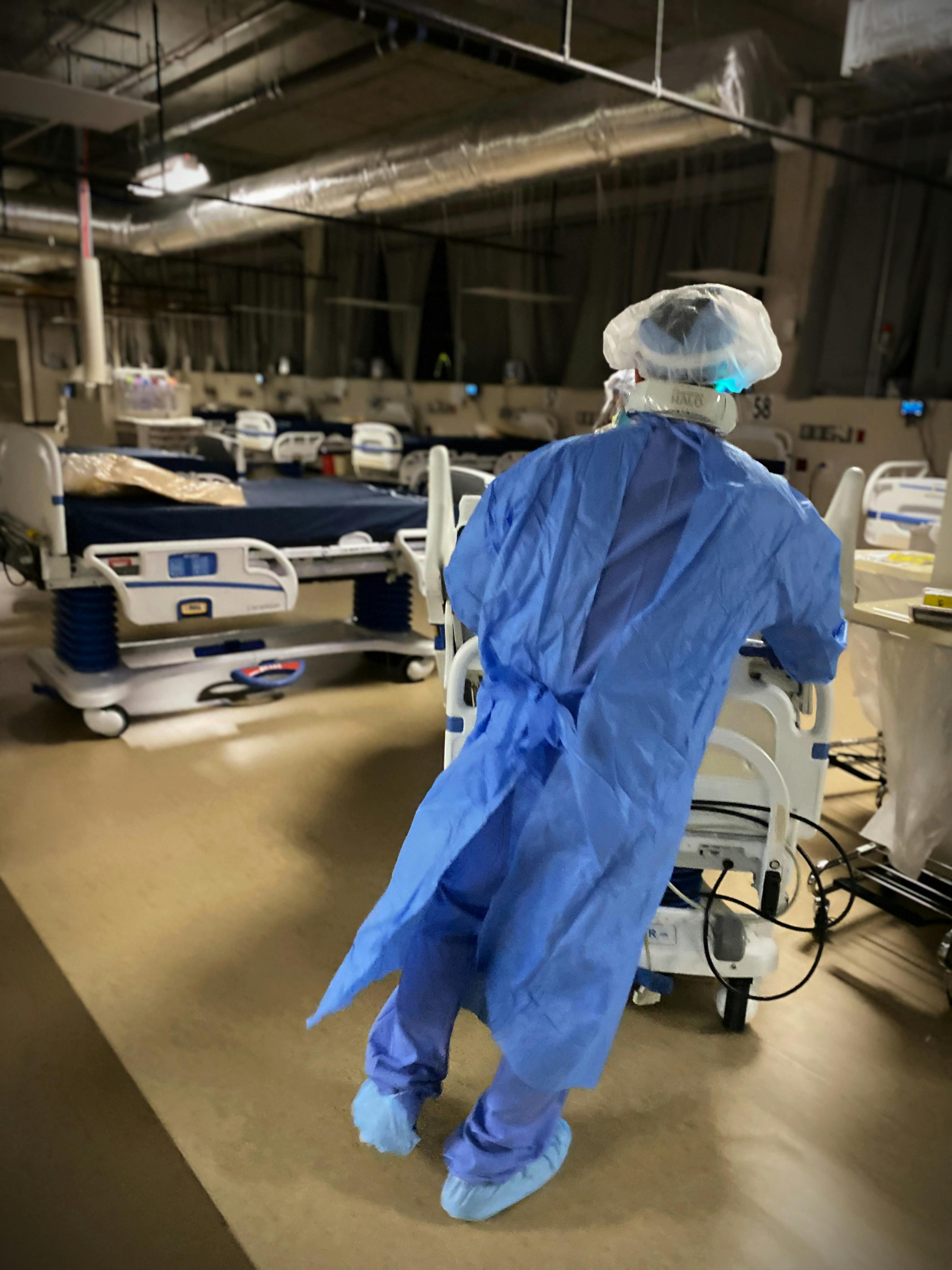 A staff member moves a patient from med-surg to ICU.