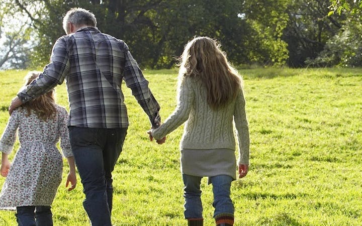 An image shows a family walking together.