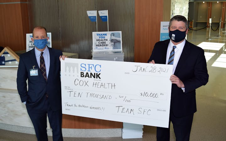 An image shows a check presentation from SFC Bank.