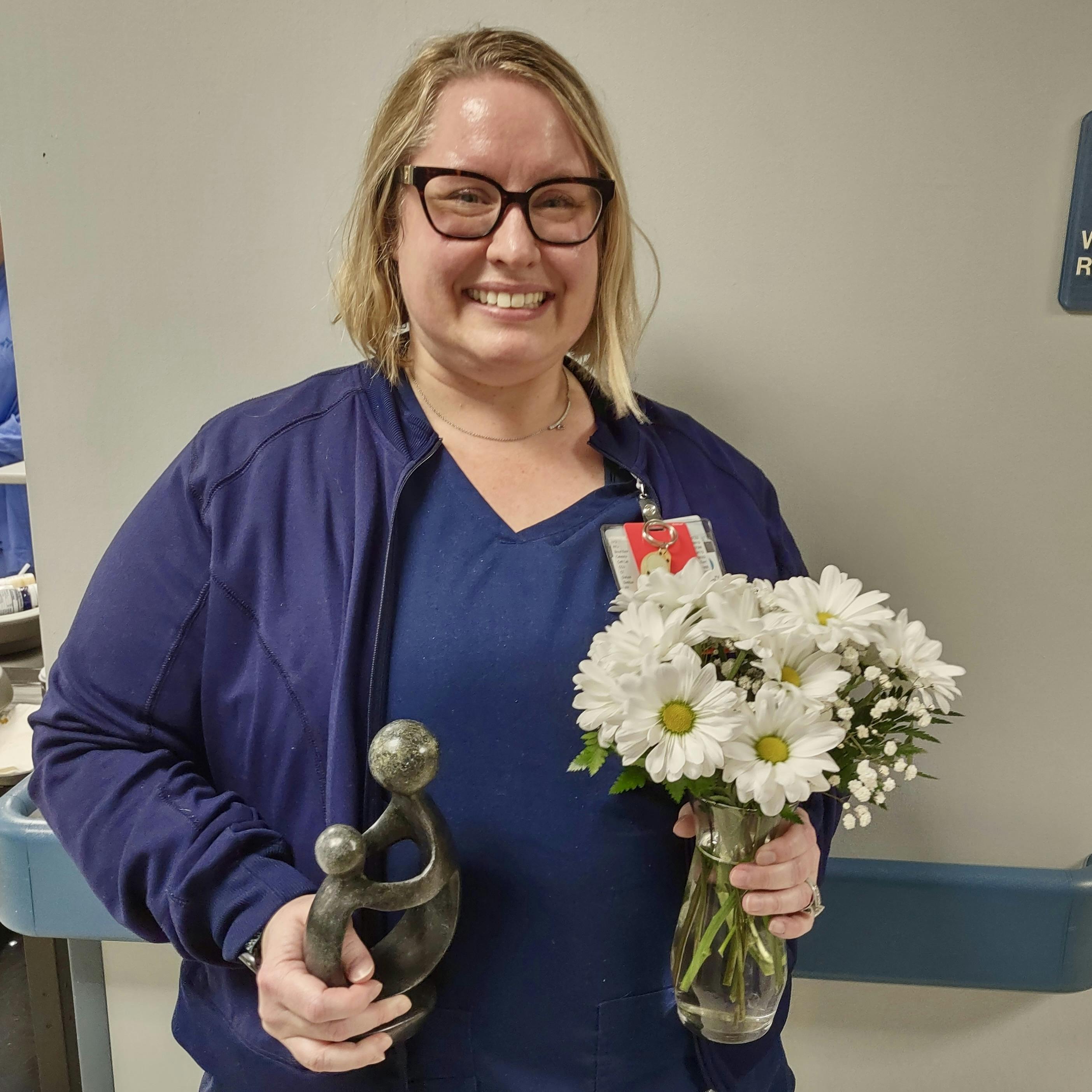 Elizabeth Gillan displays her DAISY Award.