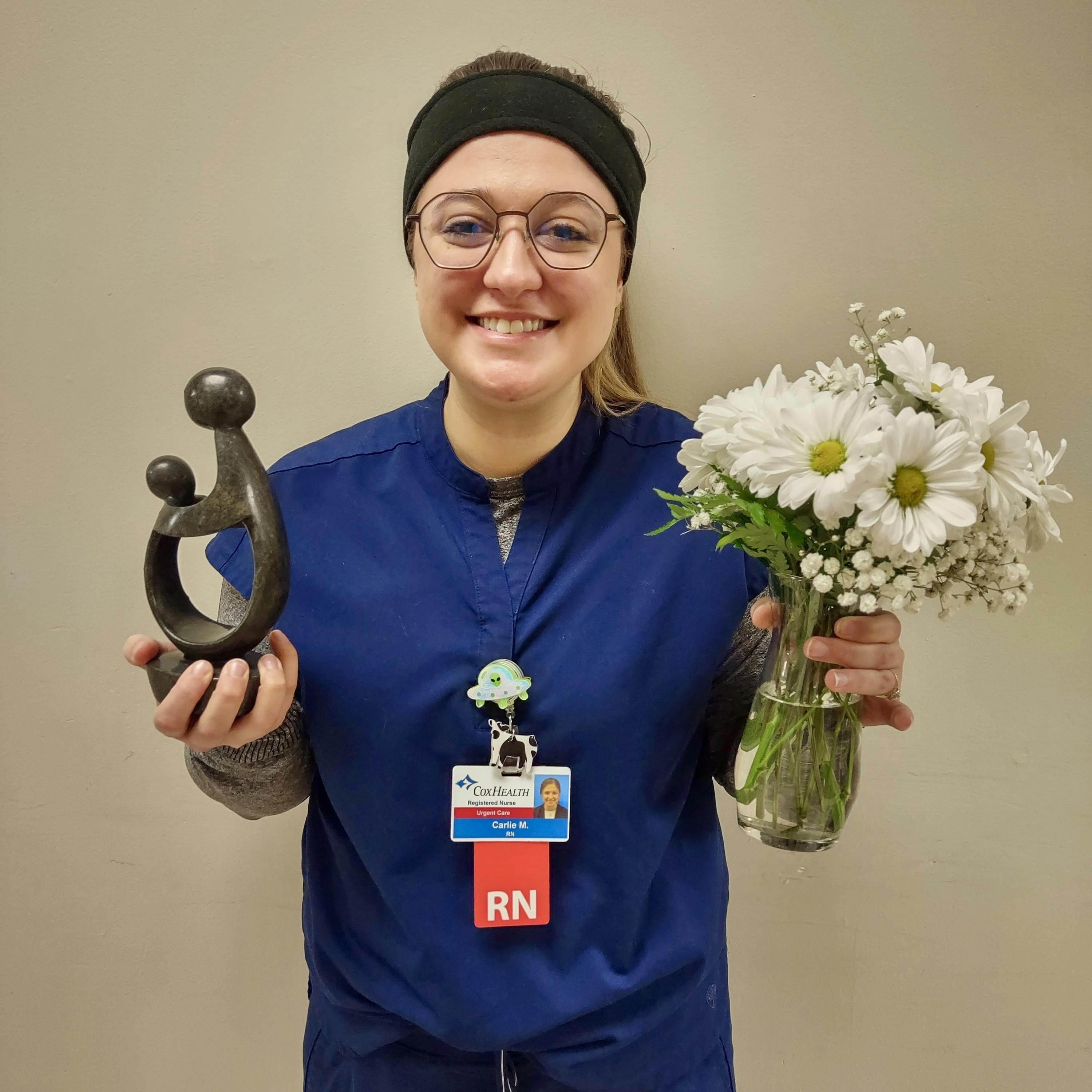 Carlie Mease displays her DAISY Award.