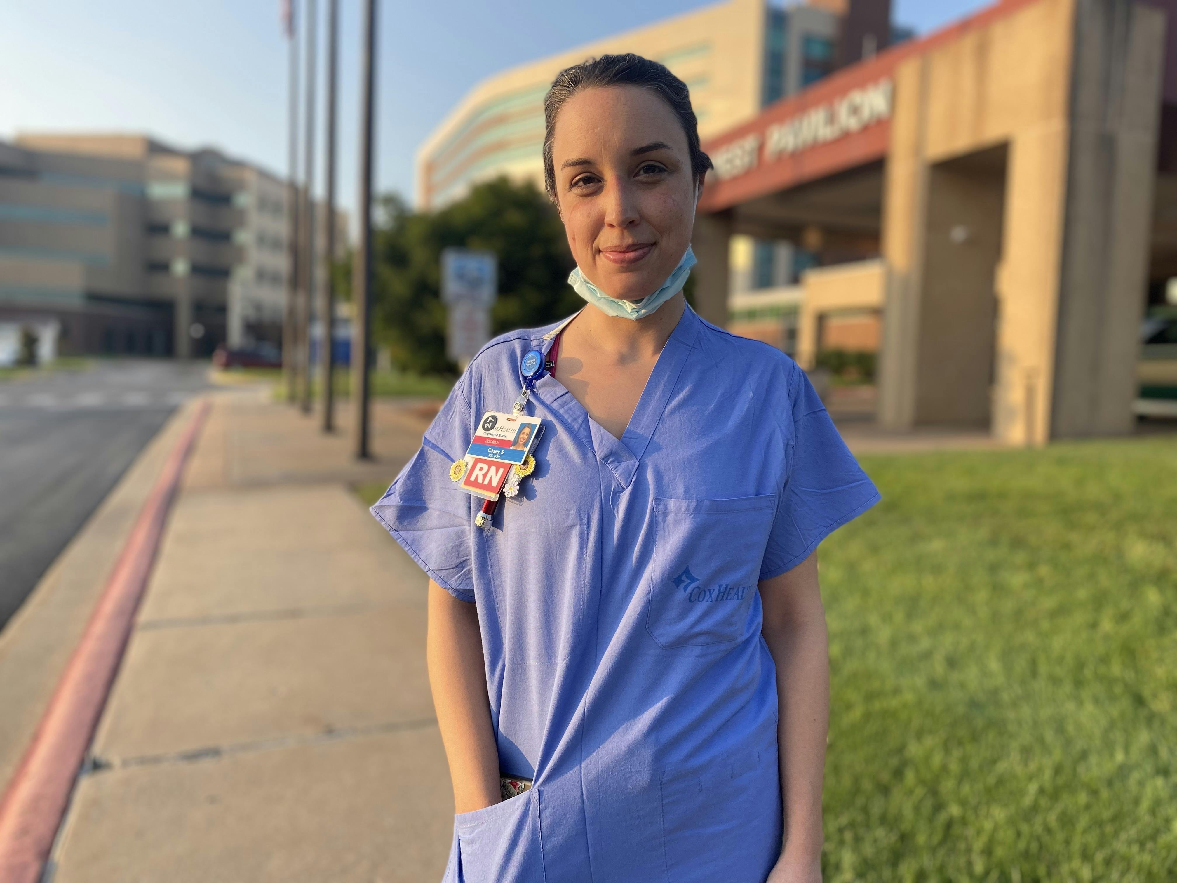 Nurse Casey Sample stands outside Cox South.