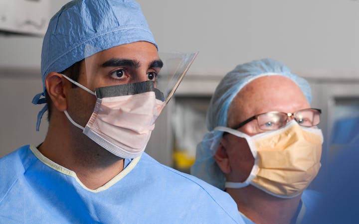 Dr. Kamyab and other doctor in scrubs and masks