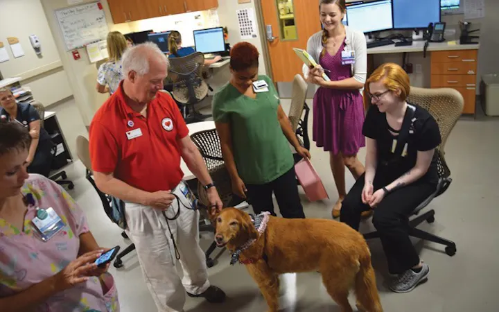 Dr. Norm Knowlton visits staff with his pet therapy dog, Lucy.