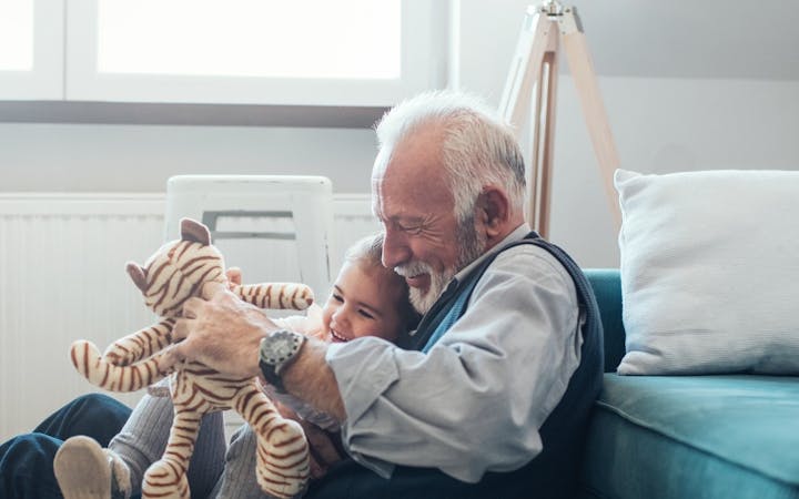 older man playing with child