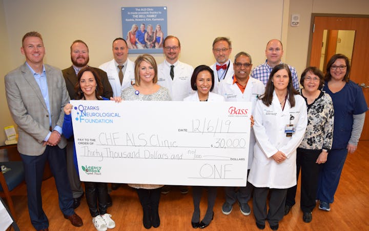 A group of CoxHealth and ONF leaders pose for a photo at the check presentation.