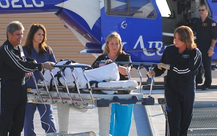 cox air care team moving patient on stretcher