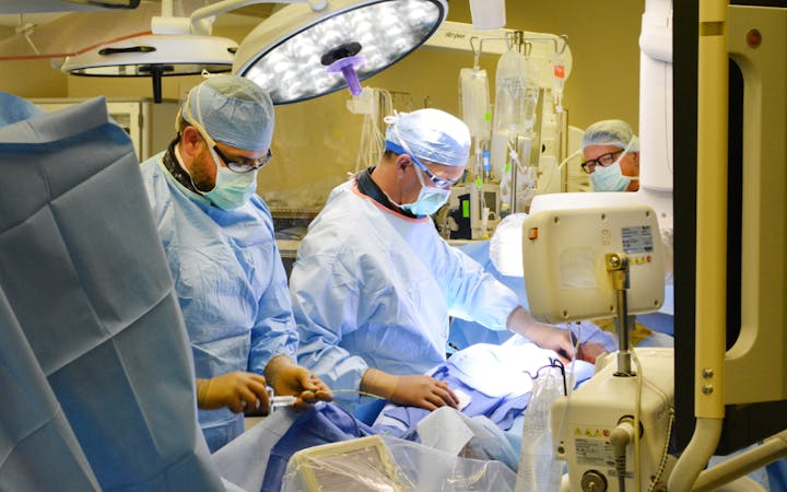 A team does a cardiovascular procedure.