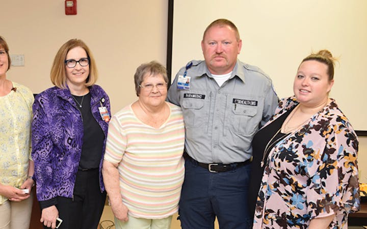 Tina King stands with a group of caregivers.