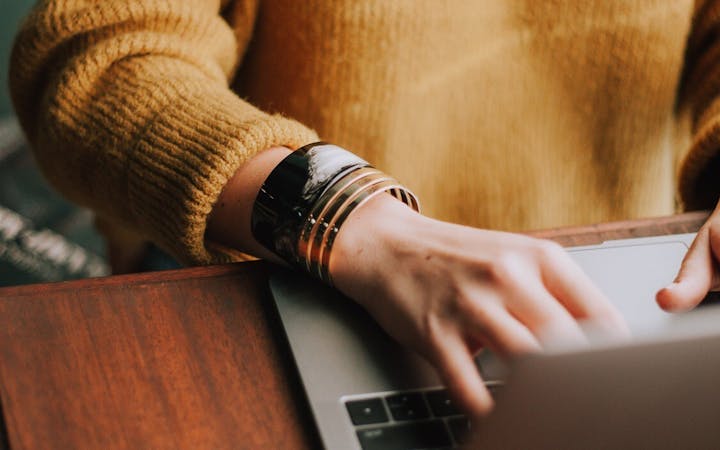 A woman sits at a computer.